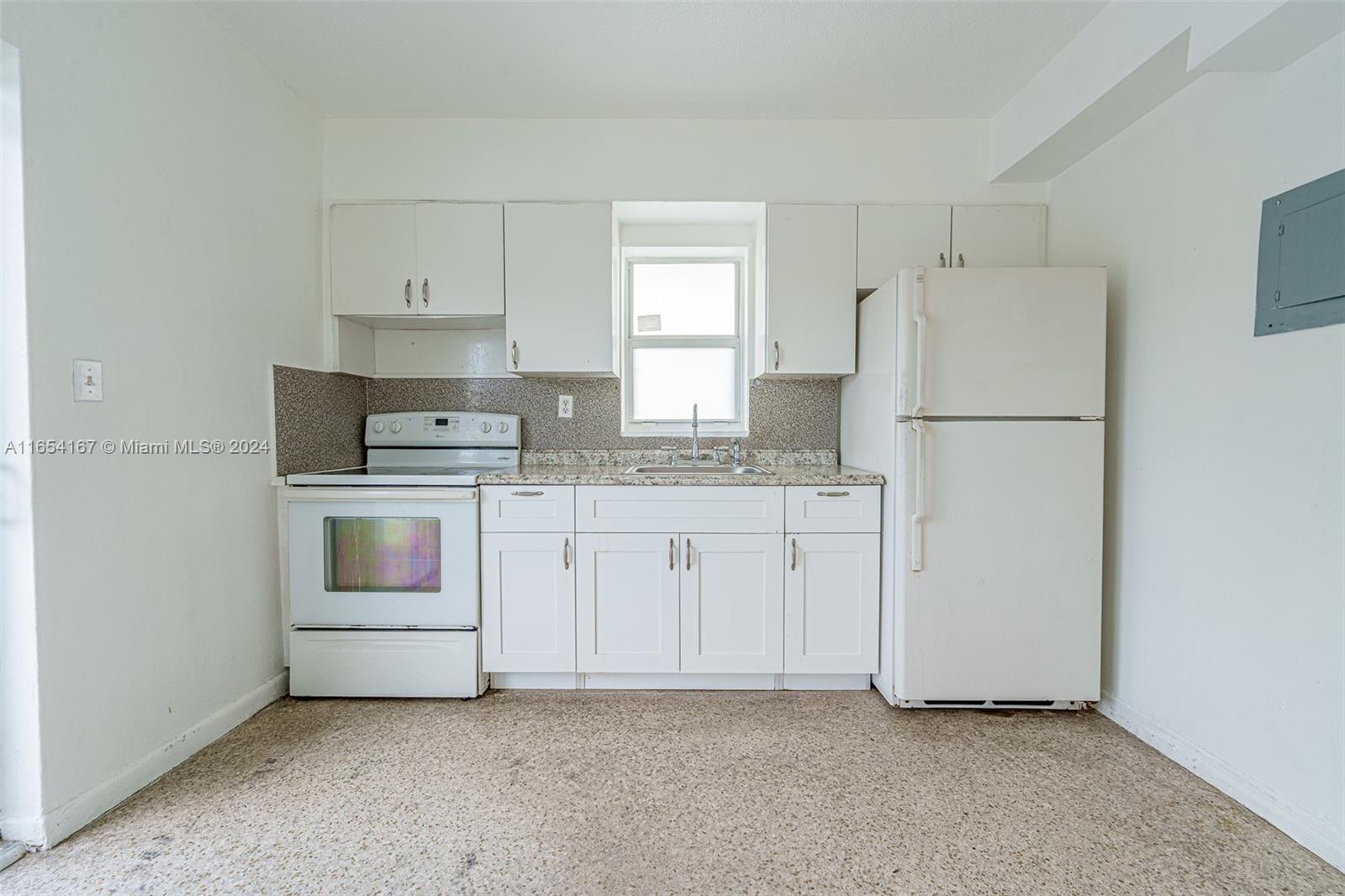 621 Southwest 15th Avenue, Unit 4 Miami, FL 33135 - Photo 16 of 22 a kitchen with white cabinets and white appliances