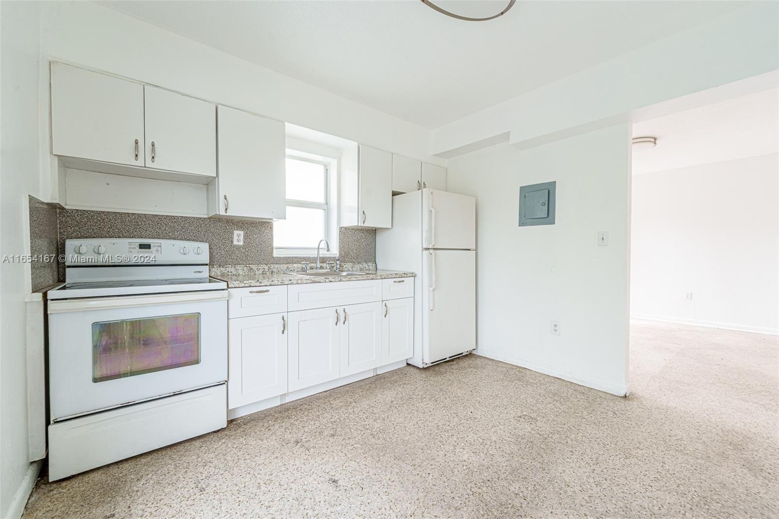 621 Southwest 15th Avenue, Unit 4 Miami, FL 33135 - Photo 17 of 22 a kitchen with cabinets appliances a sink and a window