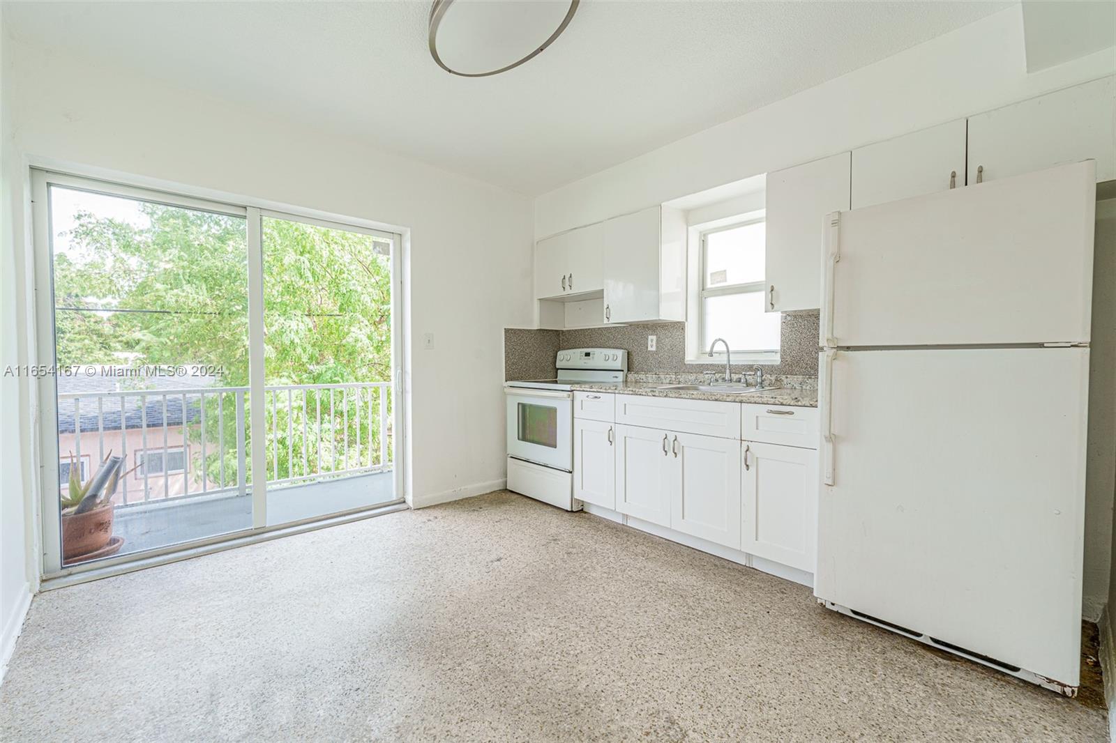 621 Southwest 15th Avenue, Unit 4 Miami, FL 33135 - Photo 18 of 22 a kitchen with white cabinets and white appliances