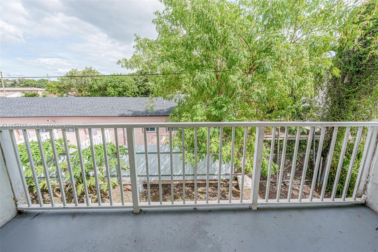 621 Southwest 15th Avenue, Unit 4 Miami, FL 33135 - Photo 7 of 22 a balcony with trees in the background