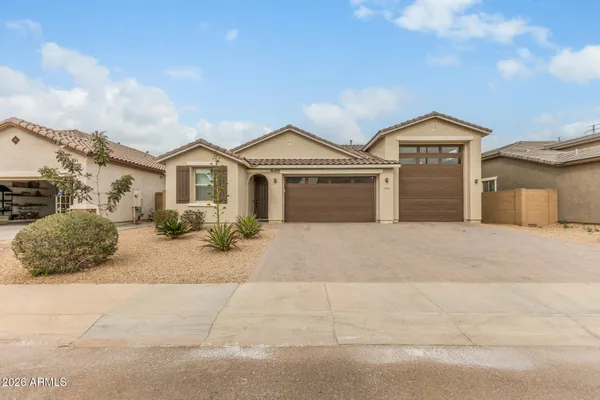 a front view of a house with a yard and garage