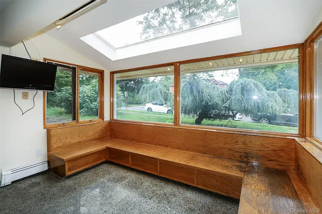 a bathroom with a large window and a view of outdoor space