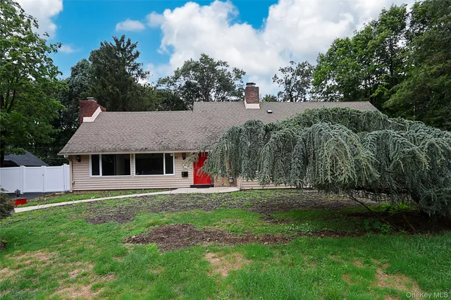 a front view of house with yard and green space