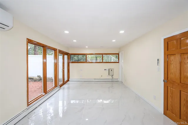a view of an empty room with glass door and shower