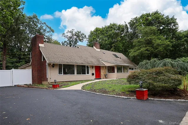 a front view of a house with lots of trees