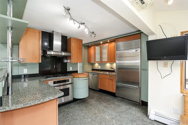 a kitchen with stainless steel appliances granite countertop a sink a stove and a refrigerator