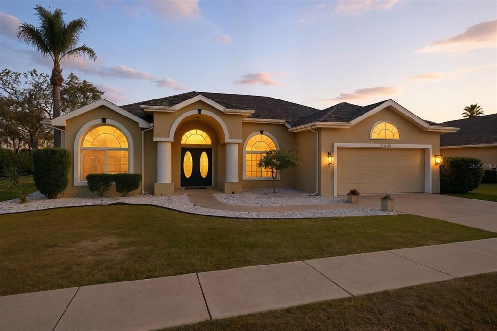 13403 Bolton Court Spring Hill, FL 34609 - Photo 1 of 36 a view of a big house with a big yard and large trees