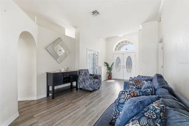 a living room with furniture and wooden floor