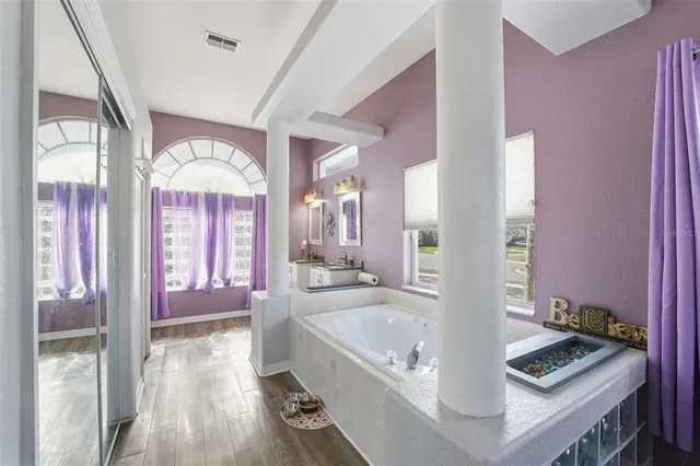 a large spacious bathroom with a large tub and shower