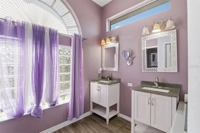 a bathroom with a sink a mirror and a window