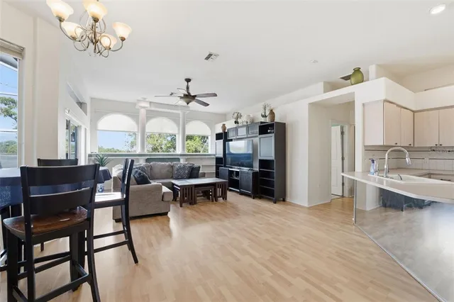a living room with fireplace furniture and a chandelier