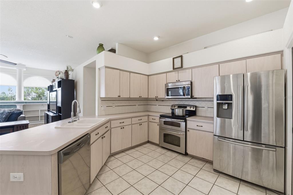 13403 Bolton Court Spring Hill, FL 34609 - Photo 20 of 36 a kitchen with granite countertop stainless steel appliances and white cabinets