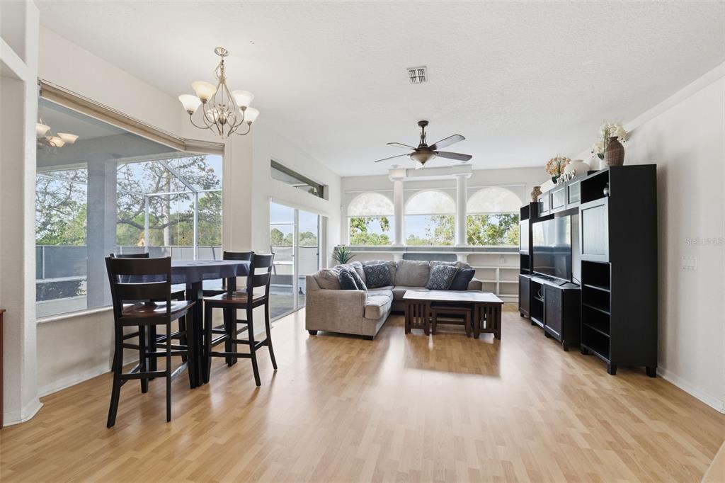 13403 Bolton Court Spring Hill, FL 34609 - Photo 23 of 36 a view of a dining room with furniture window and wooden floor