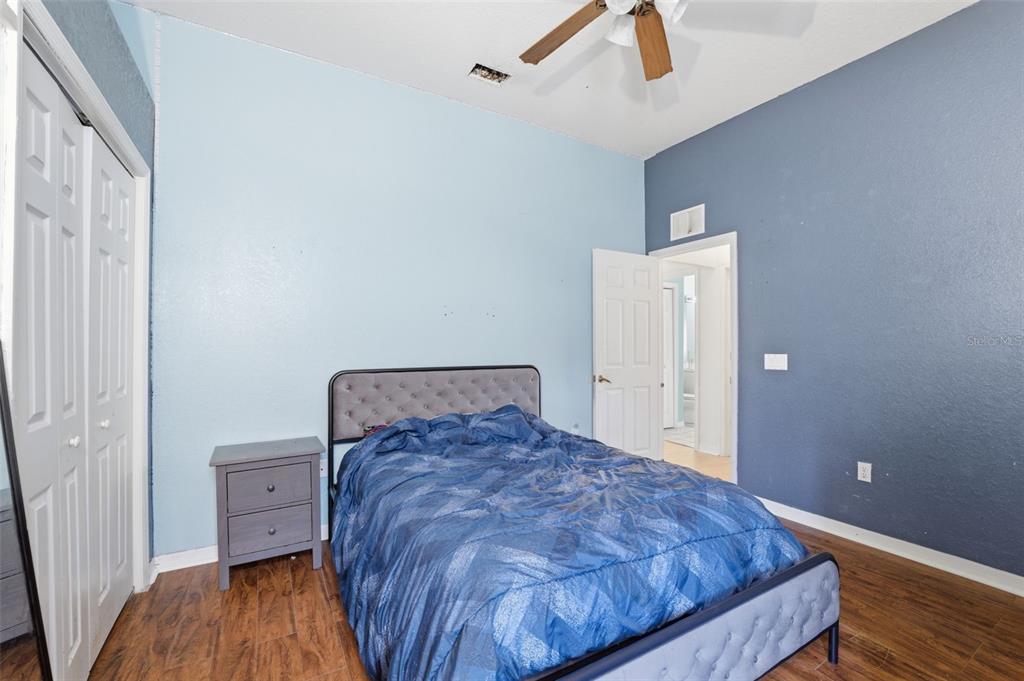 13403 Bolton Court Spring Hill, FL 34609 - Photo 30 of 36 a bedroom with a bed and wooden floor