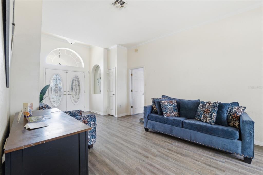 13403 Bolton Court Spring Hill, FL 34609 - Photo 10 of 36 a living room with furniture and a wooden floor