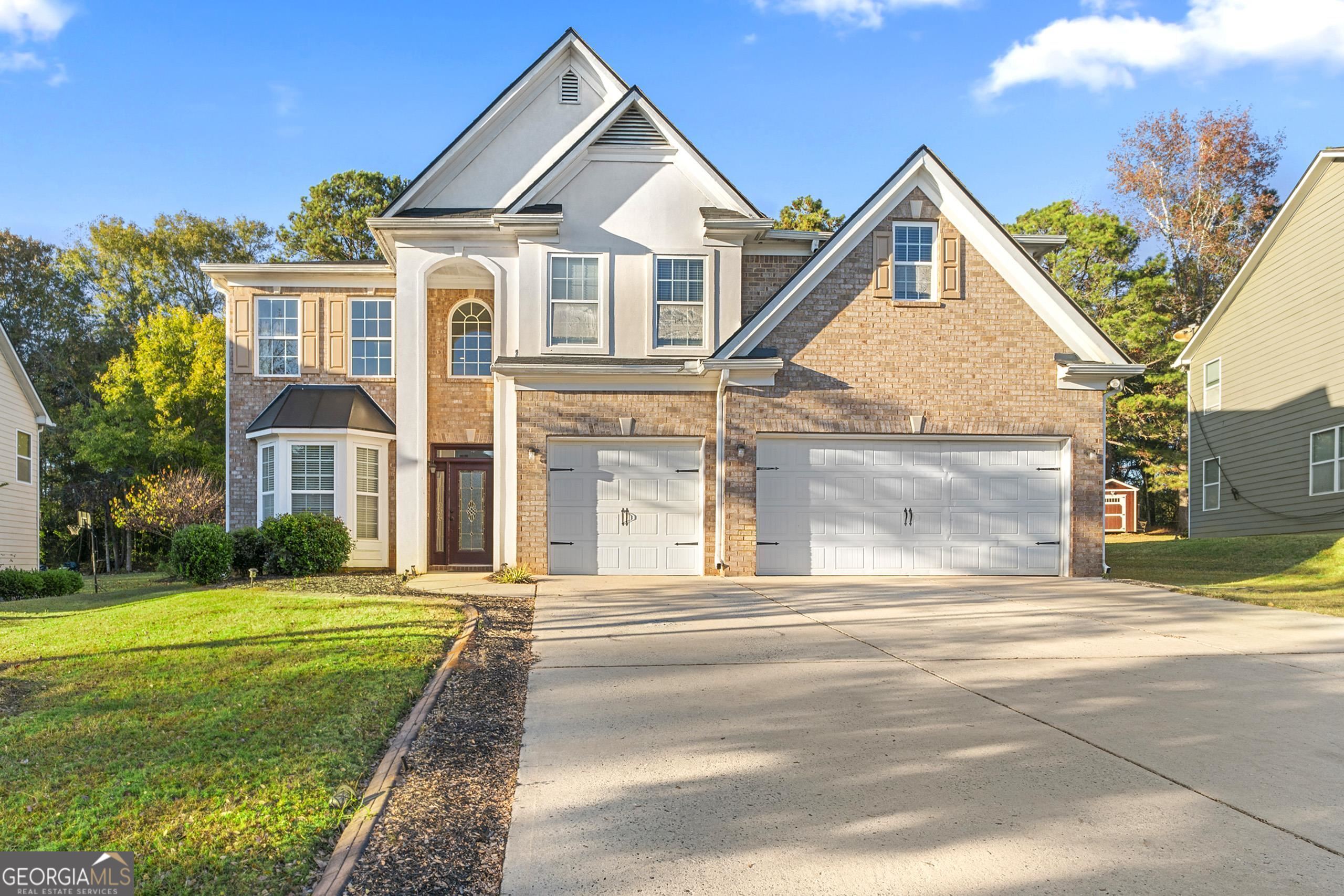 2404 McIntosh Drive Locust Grove, GA 30248 - Photo 1 of 1 a front view of a house with a garden