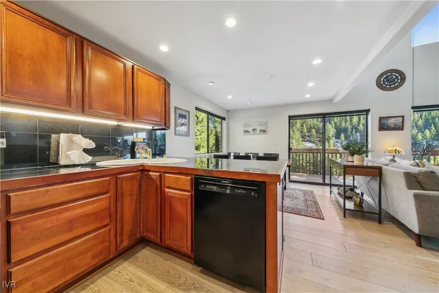 a kitchen with stainless steel appliances granite countertop wooden cabinets a sink and a stove