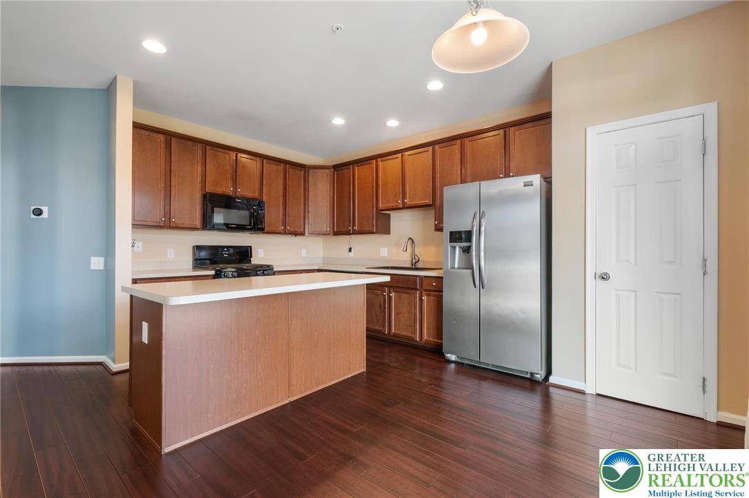 8455 Starling Road Breinigsville, PA 18031 - Photo 8 of 24 A well-appointed kitchen features rich wood cabinetry, stainless appliances, and a convenient center island.