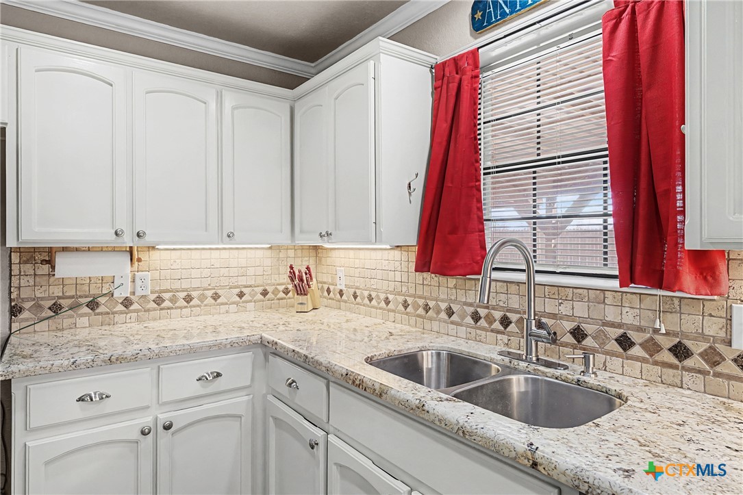 1601 Sunset Circle Cameron, TX 76520 - Photo 20 of 40 a kitchen with a sink cabinets and a window
