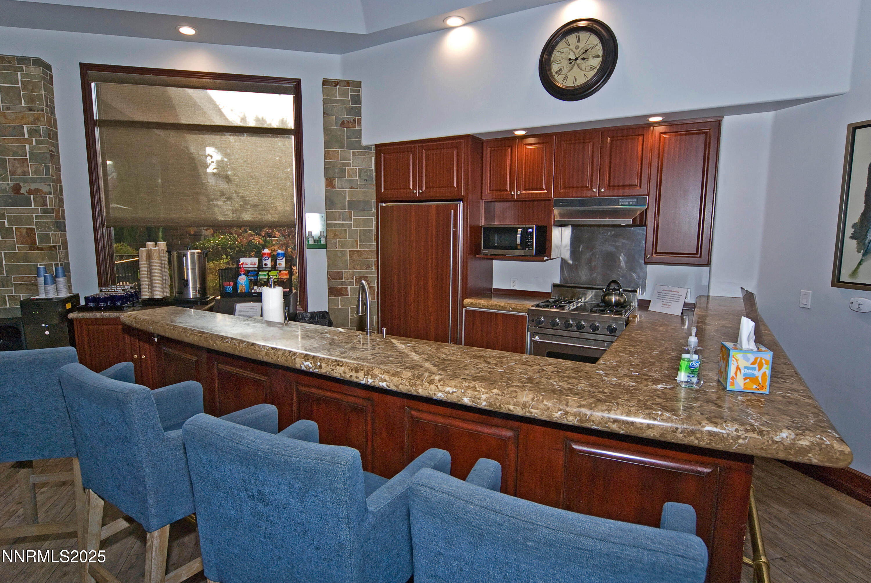 900 South Meadows Parkway, Unit 3522 Reno, NV 89521 - Photo 17 of 24 a kitchen with stainless steel appliances granite countertop a sink a stove and a wooden cabinets