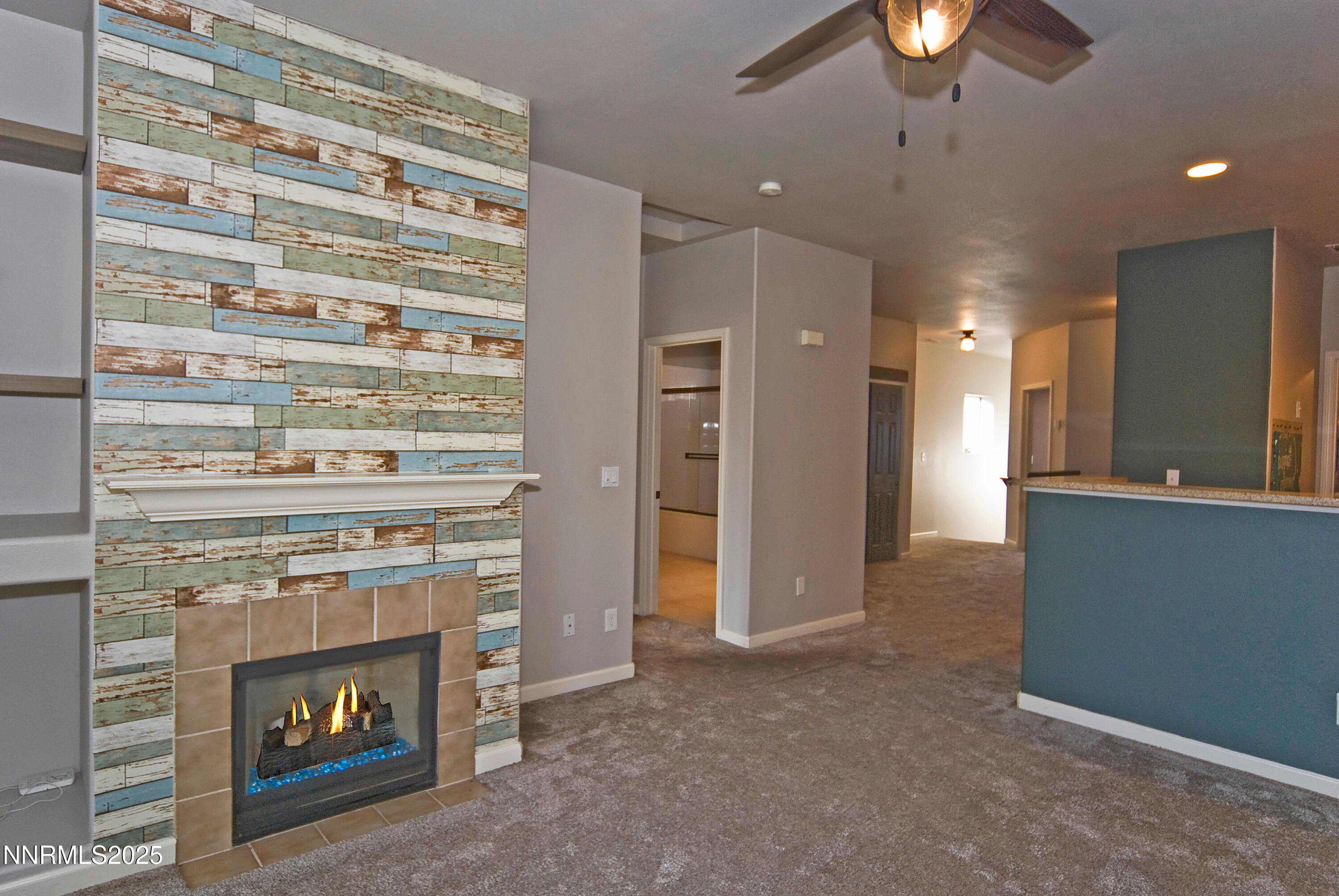 900 South Meadows Parkway, Unit 3522 Reno, NV 89521 - Photo 4 of 24 a view of an empty room with a fireplace and a ceiling fan
