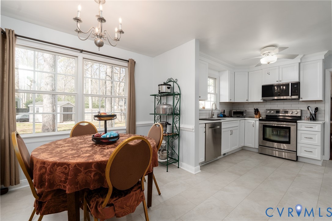 11801 Wiesinger Lane Midlothian, VA 23113 - Photo 11 of 34 a kitchen with granite countertop a stove dining table and chairs