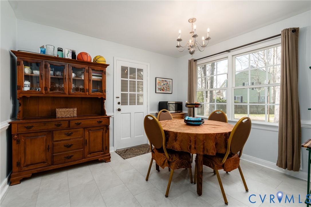 11801 Wiesinger Lane Midlothian, VA 23113 - Photo 12 of 34 a view of a dining room with furniture window and wooden floor