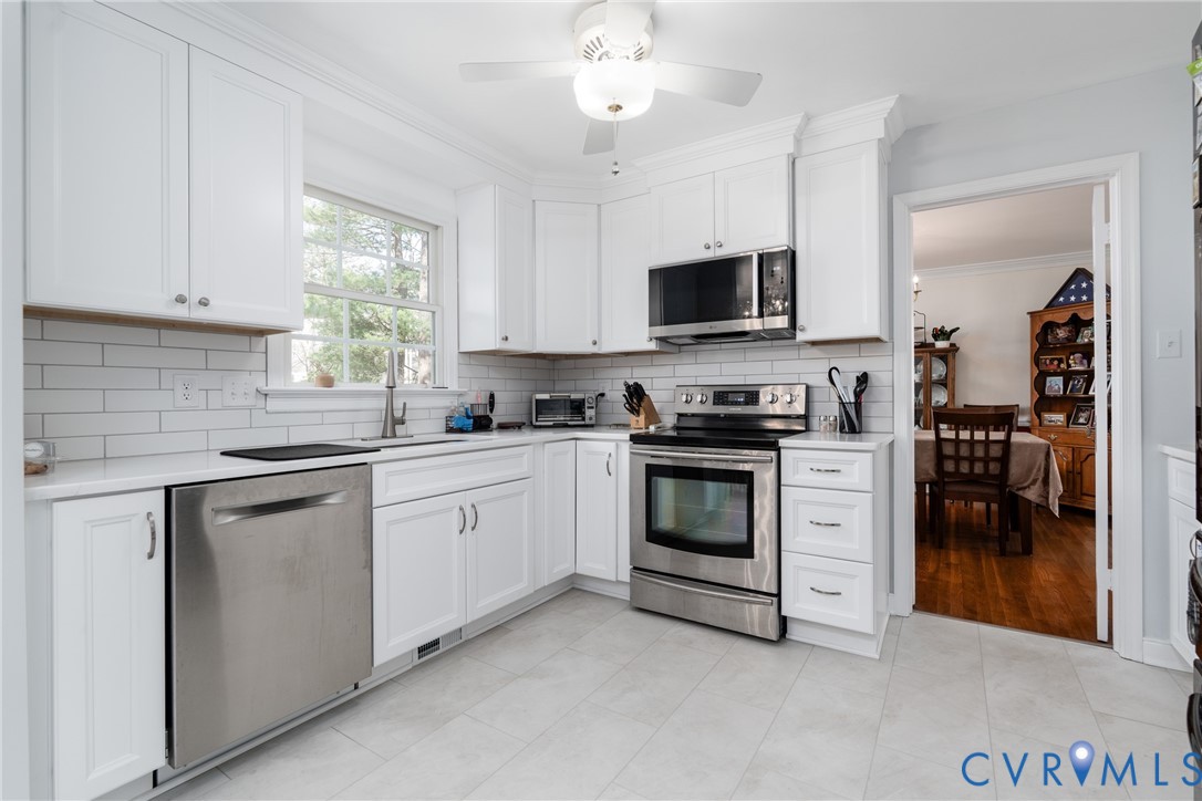 11801 Wiesinger Lane Midlothian, VA 23113 - Photo 13 of 34 a kitchen with white cabinets and appliances