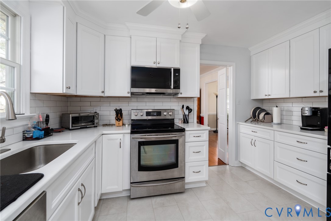 11801 Wiesinger Lane Midlothian, VA 23113 - Photo 15 of 34 a kitchen with white cabinets and stainless steel appliances