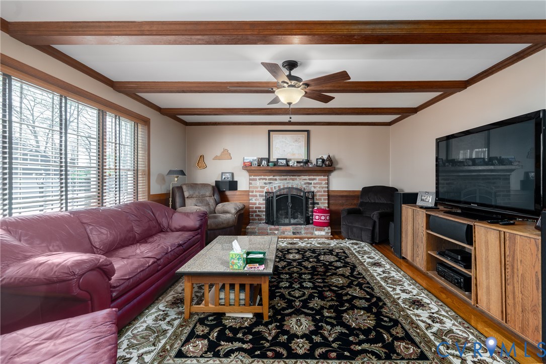 11801 Wiesinger Lane Midlothian, VA 23113 - Photo 17 of 34 a living room with furniture a flat screen tv and a fireplace