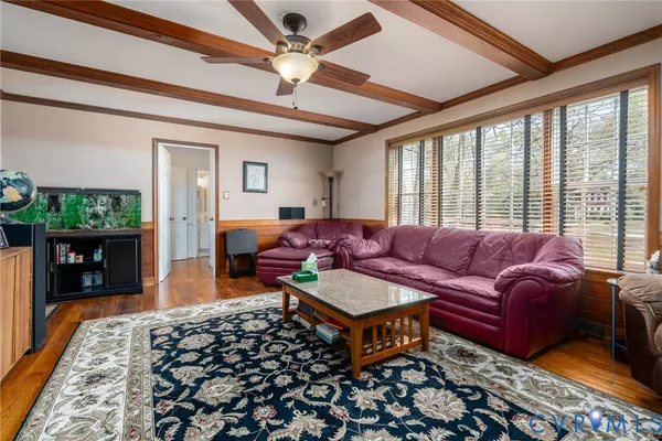 a living room with furniture ceiling fan and a rug
