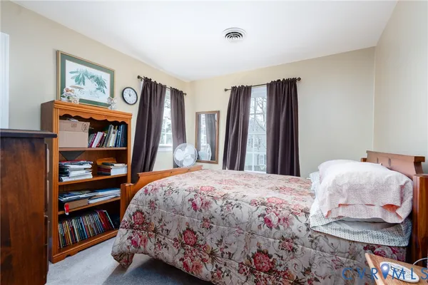 a bedroom with a bed and a book shelf