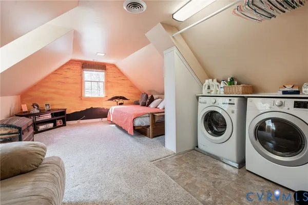 a living room with furniture and a washer dryer