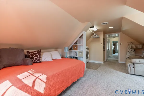 a bedroom with a bed and a couch