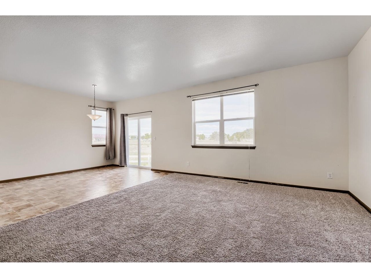 369 Naples Street Firestone, CO 80520 - Photo 14 of 29 Dining & Living Area with Mountain Views