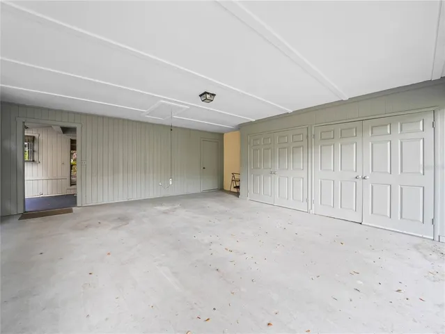 a view of a porch with furniture and floor to ceiling window