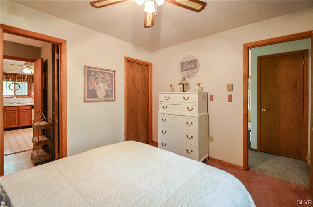 208 Regent Street Bushkill, PA 18324 - Photo 18 of 37 a bedroom with a bed and a chandelier