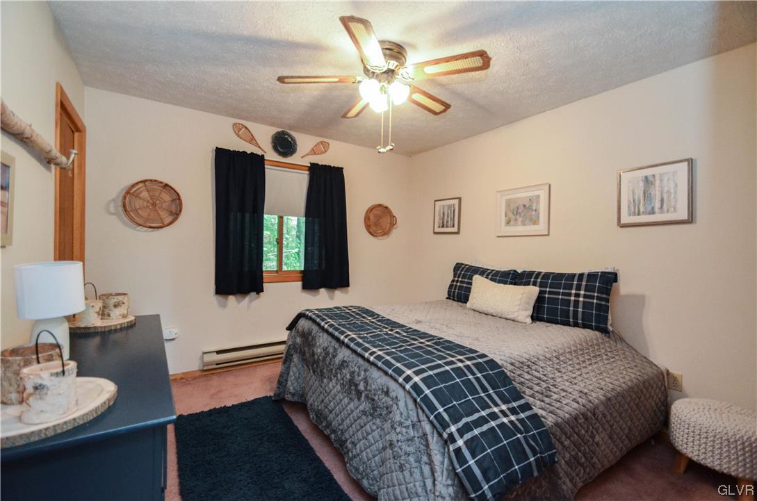 208 Regent Street Bushkill, PA 18324 - Photo 25 of 37 a bedroom with a bed and a chandelier