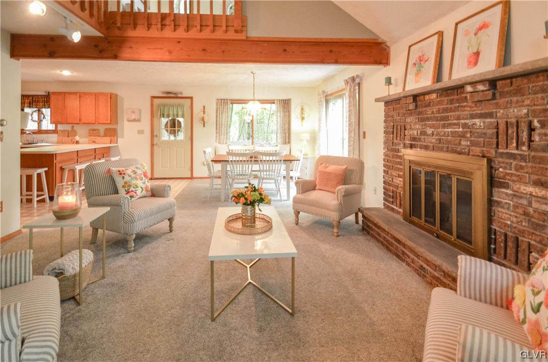208 Regent Street Bushkill, PA 18324 - Photo 3 of 37 a living room with furniture a fireplace and a table
