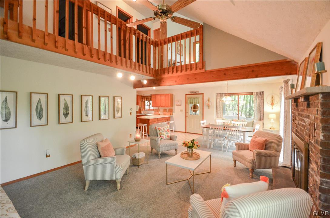 208 Regent Street Bushkill, PA 18324 - Photo 4 of 37 a living room with furniture a fireplace and a large window