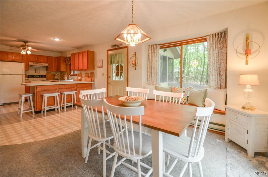 208 Regent Street Bushkill, PA 18324 - Photo 9 of 37 a dining room with furniture a chandelier and a rug
