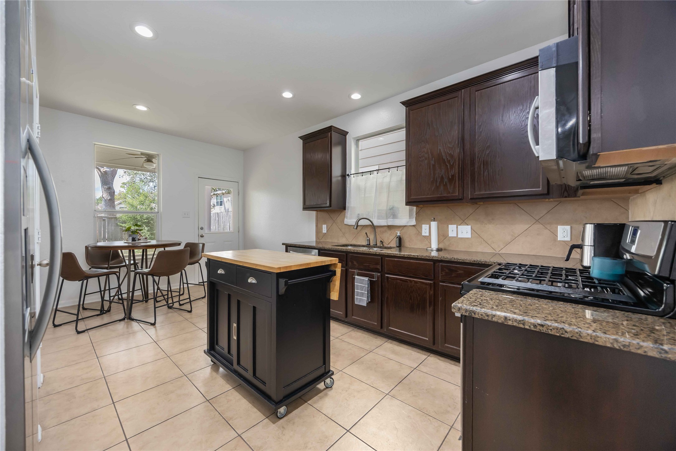 2019 Falcon Reach Drive Houston, TX 77080 - Photo 13 of 30 a kitchen with stainless steel appliances granite countertop wooden cabinets a stove top oven a sink and dishwasher