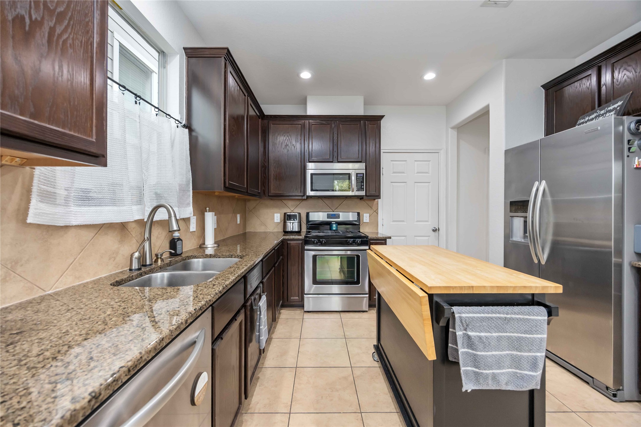 2019 Falcon Reach Drive Houston, TX 77080 - Photo 14 of 30 a kitchen with stainless steel appliances granite countertop a sink stove and refrigerator