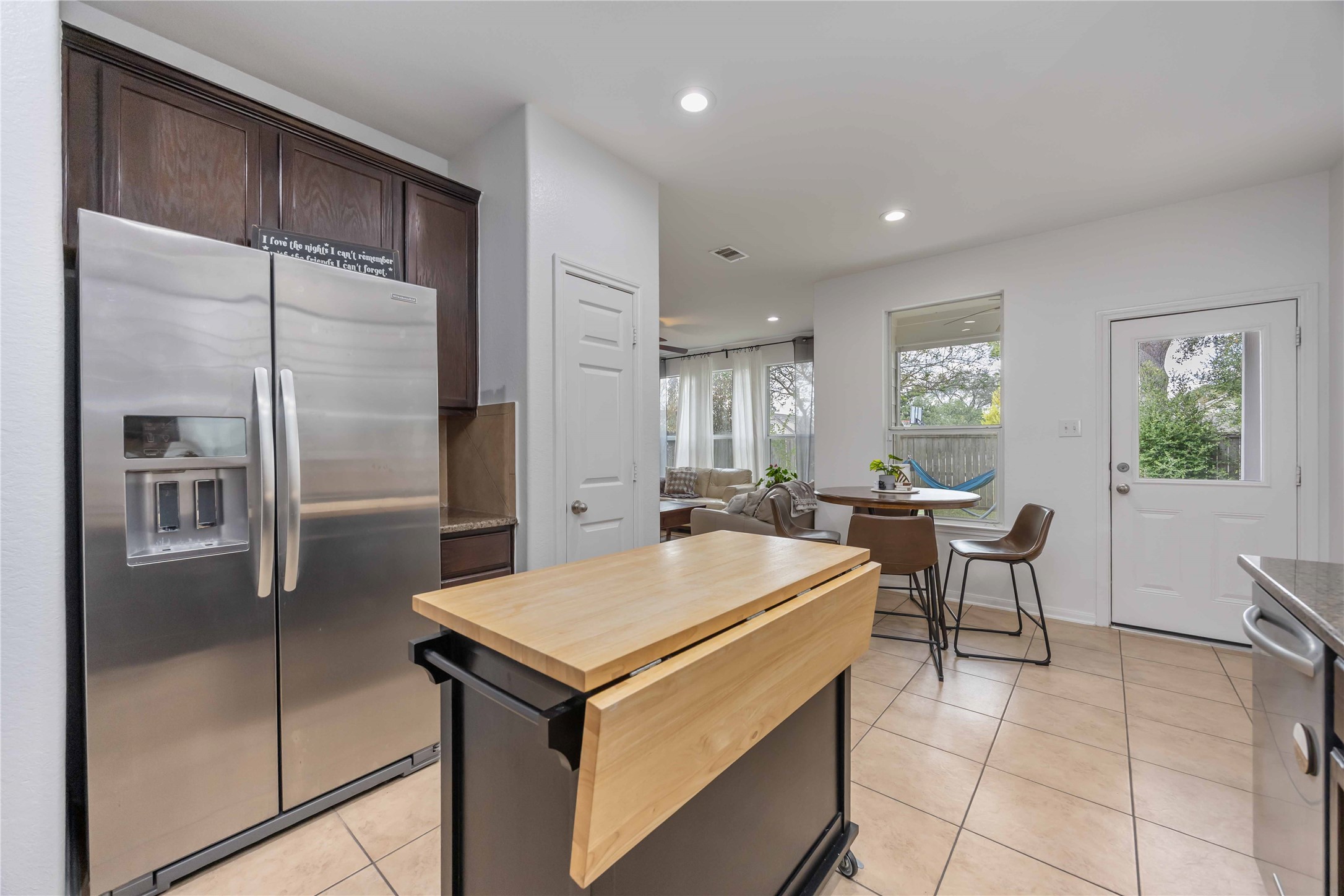 2019 Falcon Reach Drive Houston, TX 77080 - Photo 15 of 30 a kitchen with a refrigerator a sink and chairs