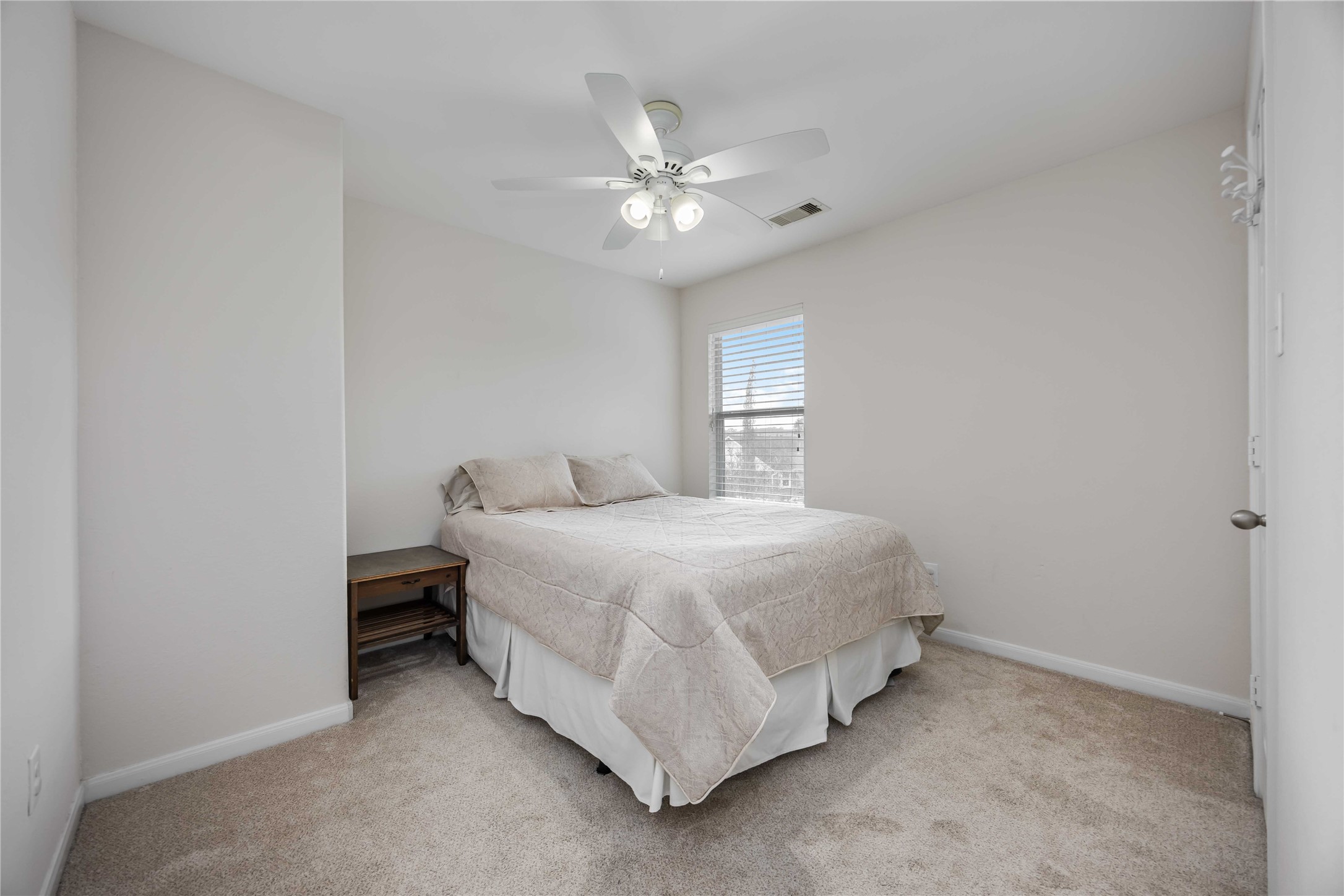 2019 Falcon Reach Drive Houston, TX 77080 - Photo 16 of 30 a spacious bedroom with a bed and a chandelier
