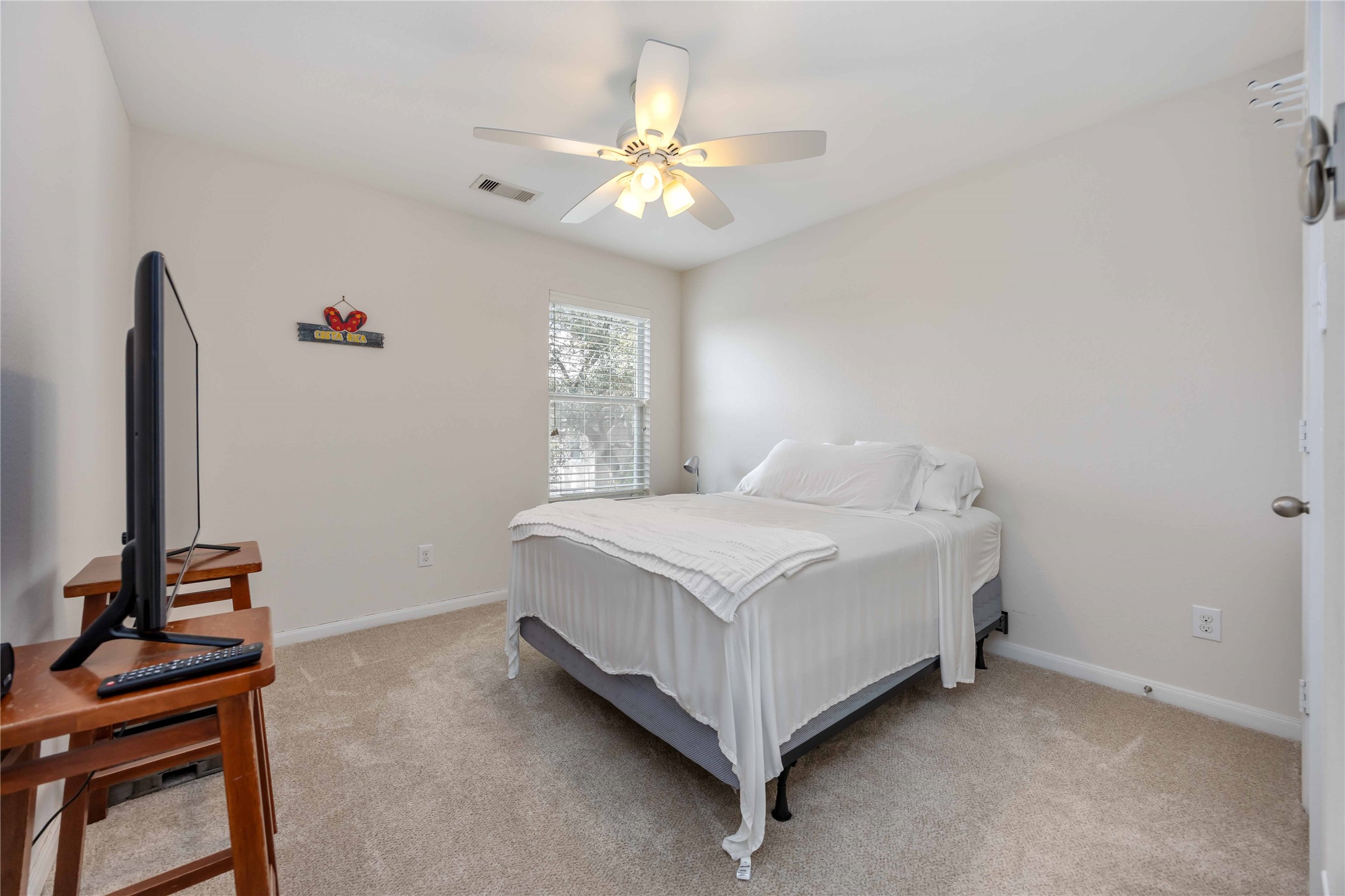 2019 Falcon Reach Drive Houston, TX 77080 - Photo 21 of 30 a bedroom with a bed and a chandelier