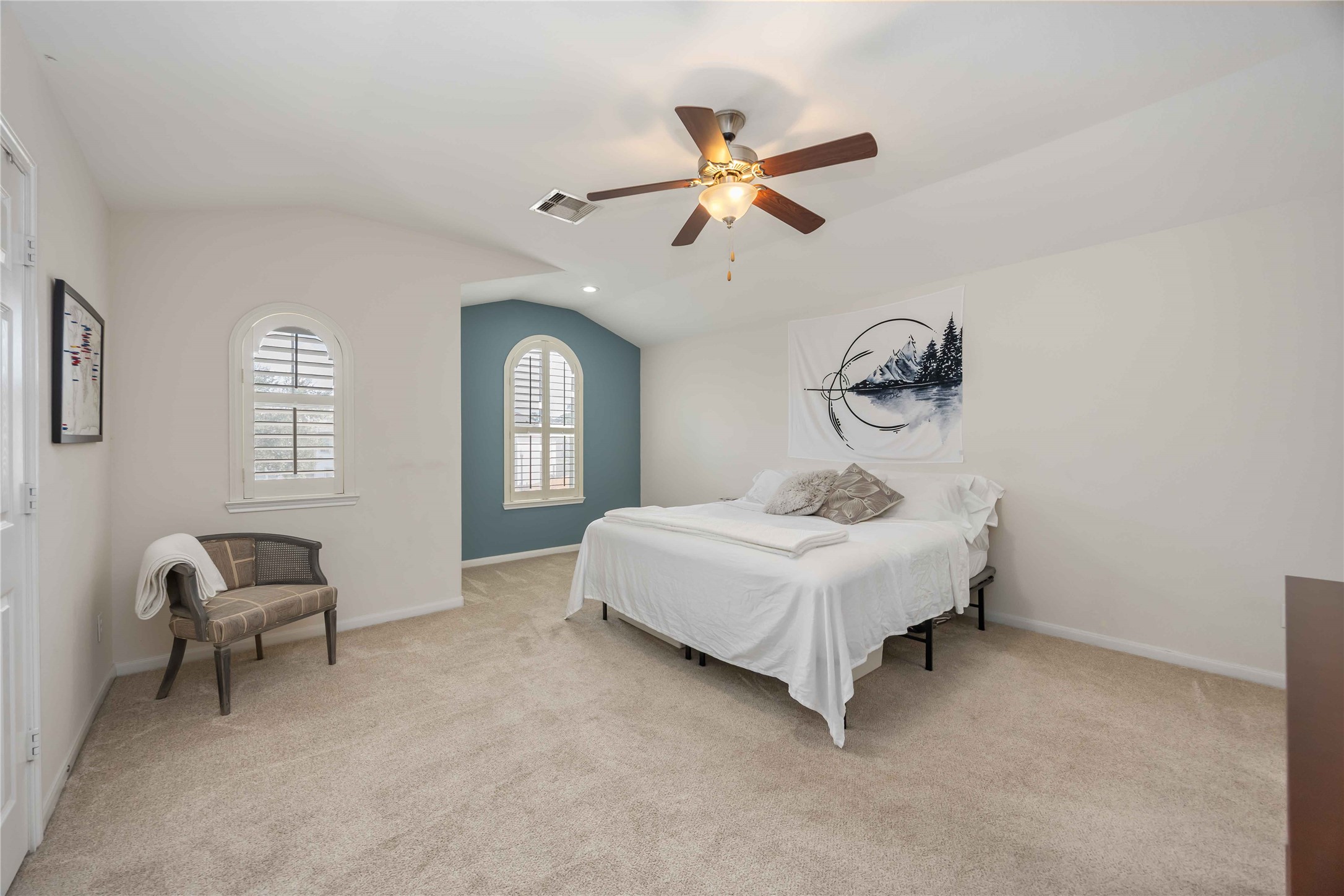 2019 Falcon Reach Drive Houston, TX 77080 - Photo 22 of 30 a bedroom with a bed and a chandelier