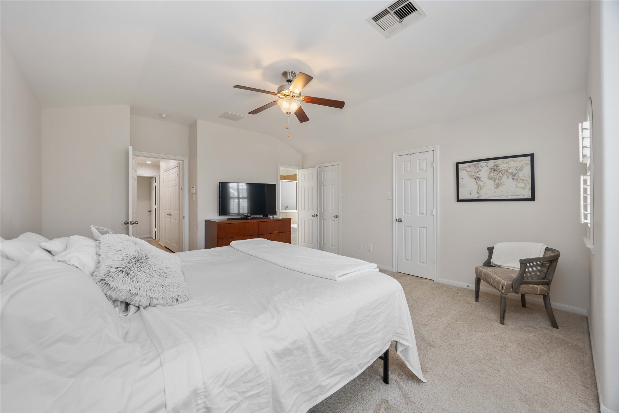2019 Falcon Reach Drive Houston, TX 77080 - Photo 24 of 30 a bedroom with a bed and a chandelier