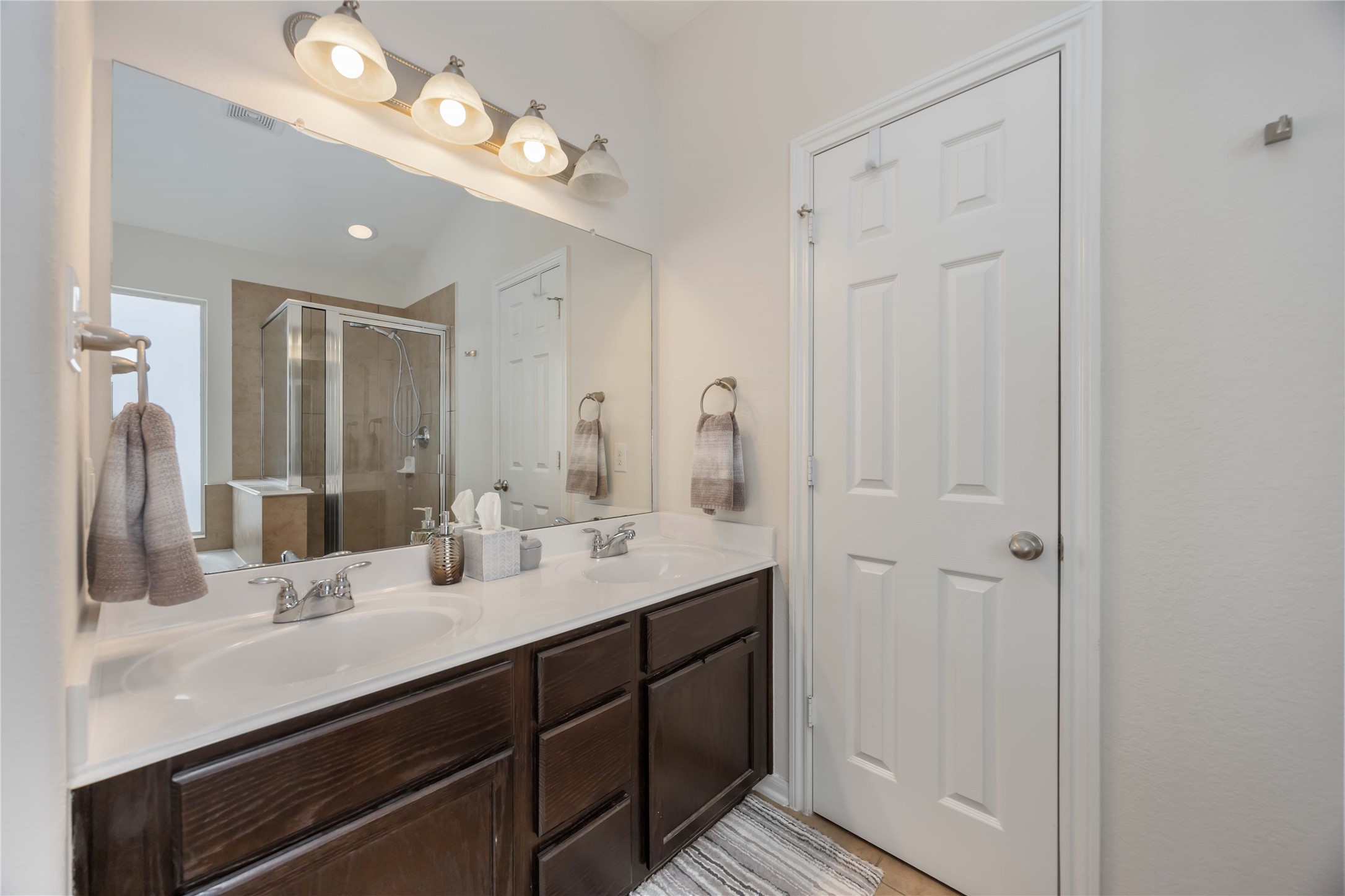 2019 Falcon Reach Drive Houston, TX 77080 - Photo 25 of 30 a bathroom with a double vanity sink and a mirror
