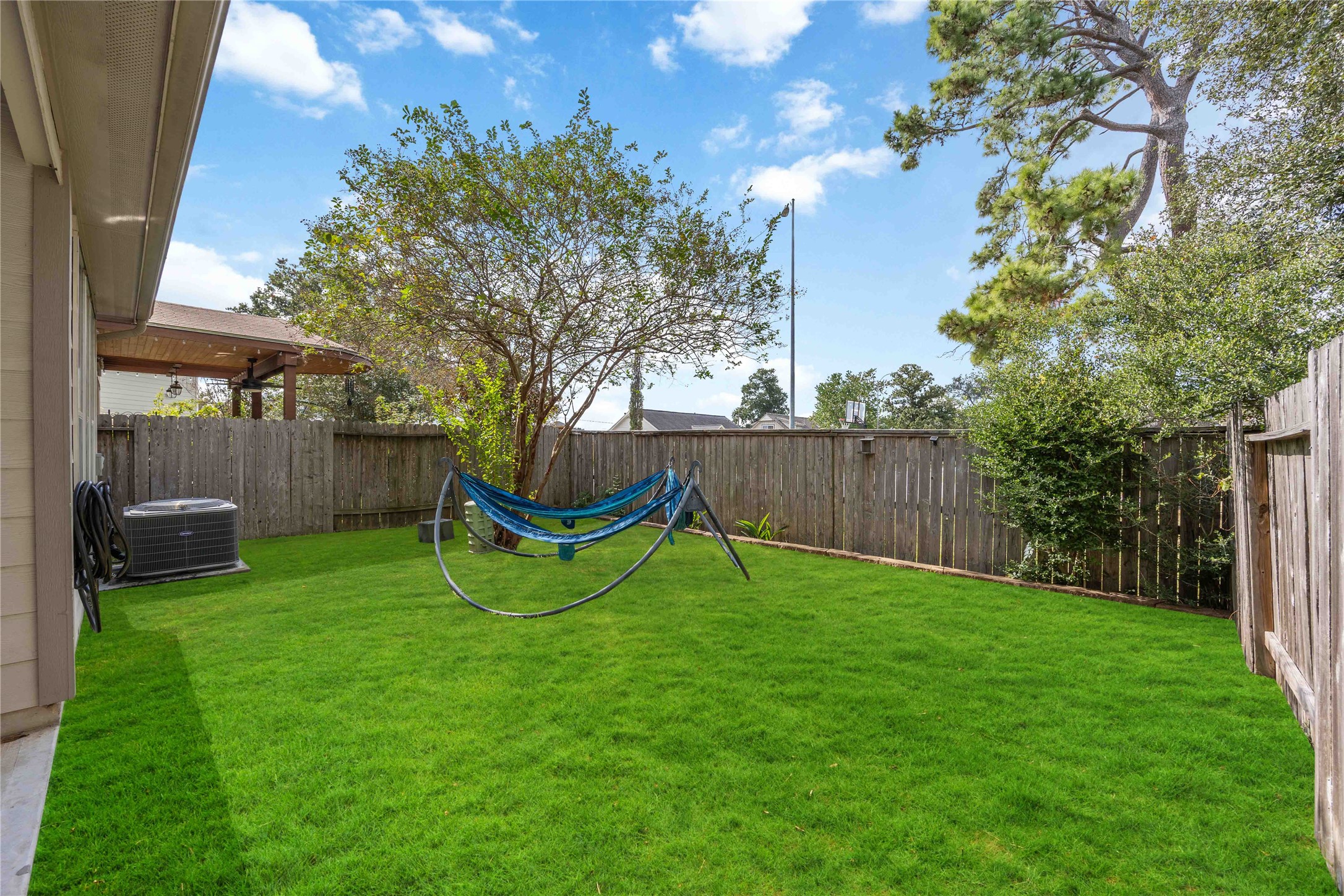 2019 Falcon Reach Drive Houston, TX 77080 - Photo 29 of 30 a view of a backyard with table and chairs and a tree